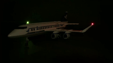 Animated gif showing flashing LED lights on a LEGO airplane.